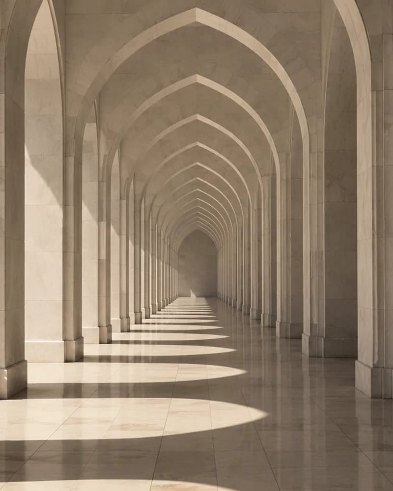 Sunlight through a marble colonnade of pointed arches